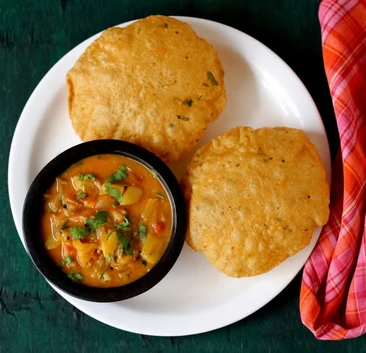 Aloo puri, puffed puris with spiced potato curry, at Pind Di Roti in Toronto